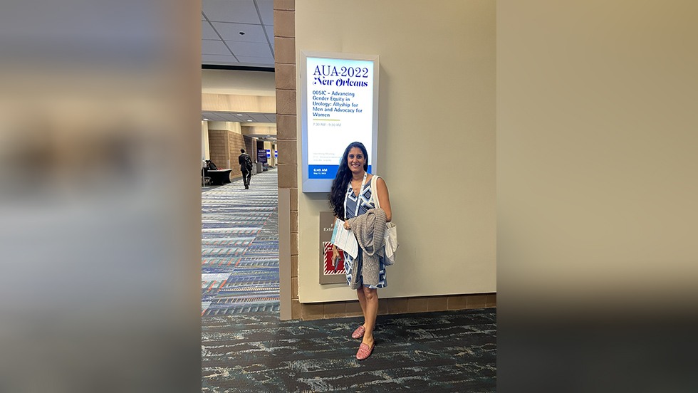 person posing near sign