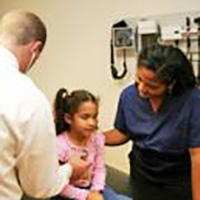 child and adult in a doctor's office